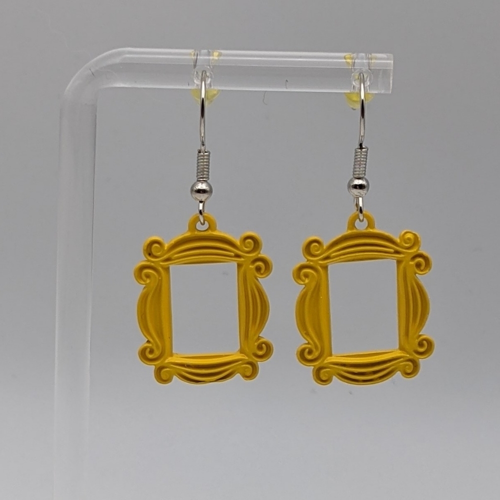 Friend's yellow peephole frame drop earrings